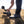 Person filming in a field with a camera and stabilizer